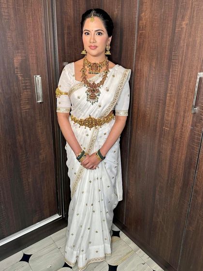 A vision in white and gold. For this pre-wedding pooja, I created a divine look with antique gold jewelry and makeup that highlighted her natural features.
