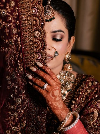 A beautifully artistic shot of my bride Ashima. This photo captures the delicate eye makeup and the intricate details of her henna and bridal veil.