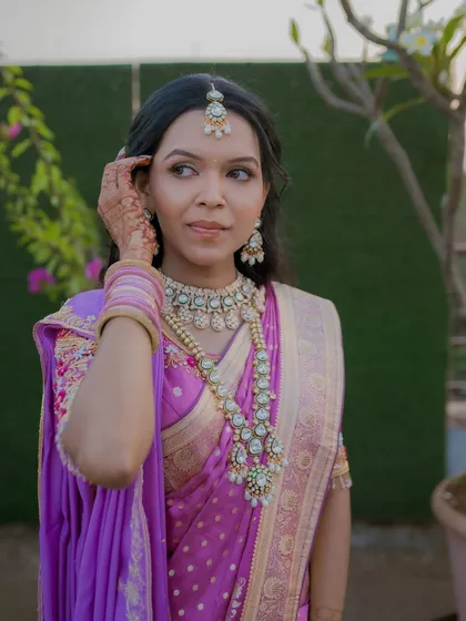 A candid shot of the engagement bride. Her hair is styled in soft waves, and the makeup is kept elegant and understated to let her natural beauty shine.