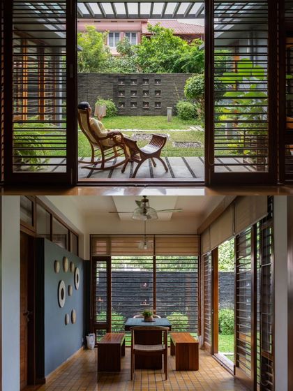 The 'Kayyalackakom Residence' by Jibu and Thomas Architects is designed for tropical living, with louvered wooden shutters that allow for ventilation while providing privacy.