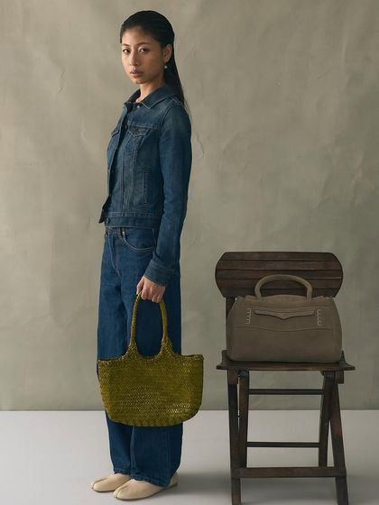 The Penny Carryall in suede, seen here next to our Foyer Bamboo bag. It’s a perfect example of how we play with different textures to create statements.