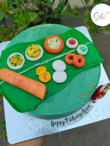 A feast for the eyes and the tummy. This unique cake is designed to look like a traditional South Indian meal served on a banana leaf, with all the dishes sculpted from fondant.