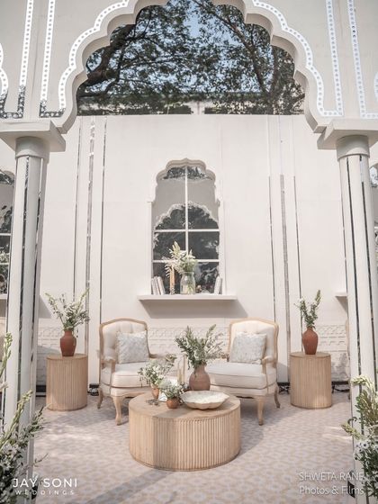 A perfectly symmetrical seating arrangement within one of the arched alcoves, creating a sense of order and calm elegance in the lounge area.