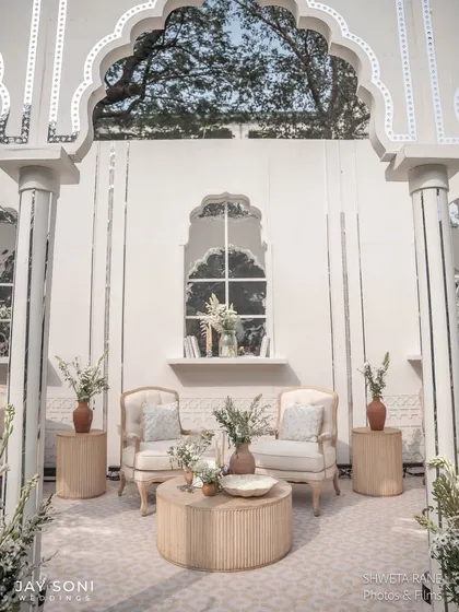 A perfectly symmetrical seating arrangement within one of the arched alcoves, creating a sense of order and calm elegance in the lounge area.