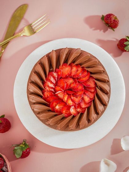 An overhead shot of our Strawberry Chocolate Tart, showcasing the beautiful arrangement of sliced strawberries over a rich chocolate ganache.