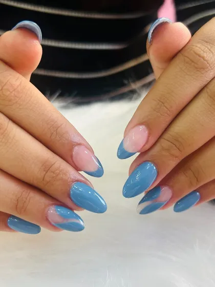 A chic and modern design with a dusty blue polish and abstract swirl accents.