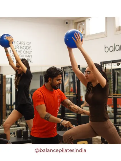 Here's a glimpse of a group session in action. Clients are using stability balls for an added challenge, with a trainer right there to guide and correct form.