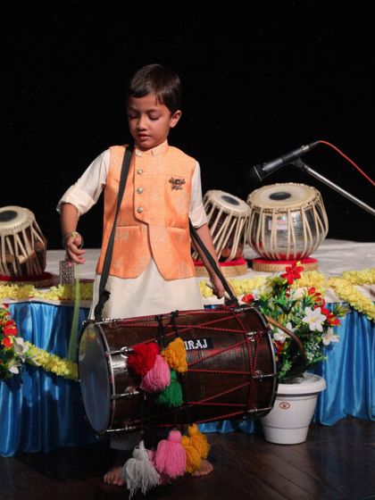 A young student, Aviraj Singh, confidently performing on the dhol at our academy's concert.