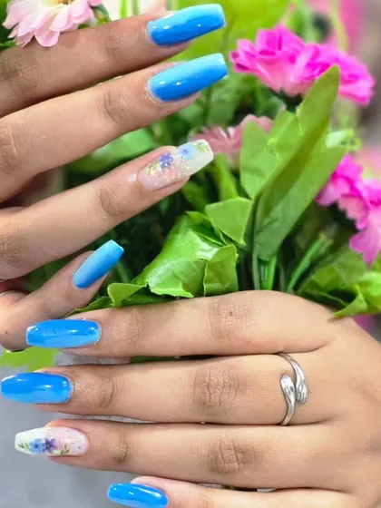 A stunning blue ombre set with a floral accent nail, created by my talented student Pallavi.