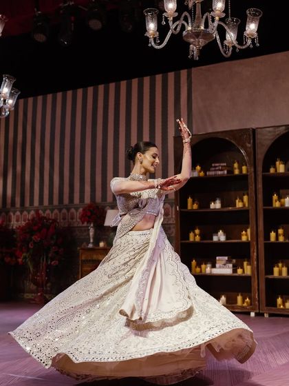 Another action shot of the bride dancing, showcasing her grace and the beautiful movement of her outfit.
