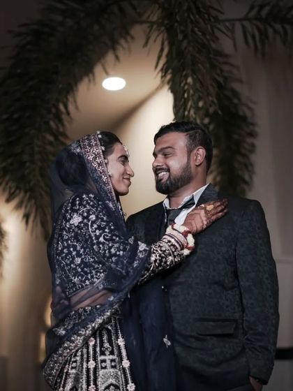 A playful and romantic moment between a couple during their evening reception photoshoot.