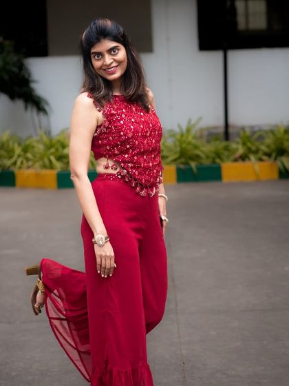 A playful and confident outdoor portrait. This full-body shot captures a fun, energetic moment, perfect for lifestyle or fashion photography.