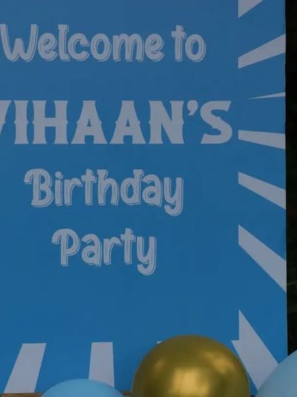 The welcome sign for the carousel party, dimly lit at night.