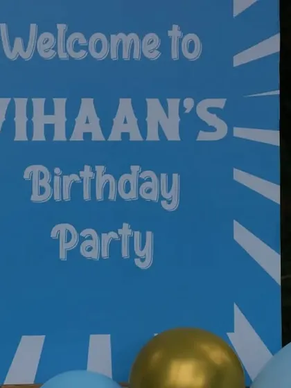 The welcome sign for the carousel party, dimly lit at night.