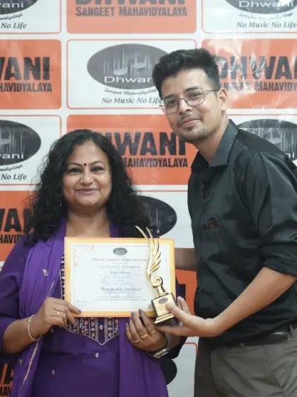 A teacher presents an award to an adult student.