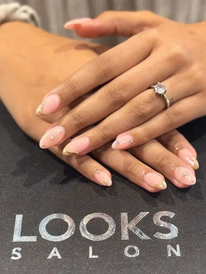 A clear, still shot of the delicate gold-tipped manicure. This style is perfect for those who want a touch of elegance without committing to a bold design.