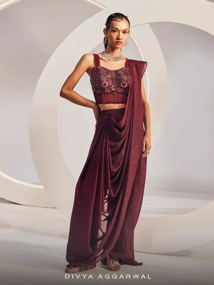 A full-length view of the maroon ISLA Saree Set, showcasing the pre-draped saree and embellished corset blouse.