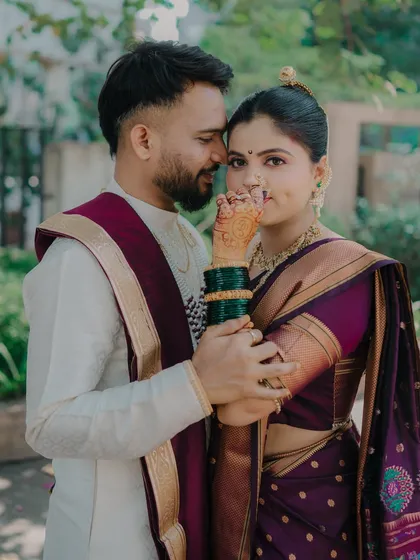 A lovely portrait where the bride's henna-adorned hand is the focus. This pose is both traditional and intimate, highlighting important cultural details while capturing the couple's closeness.
