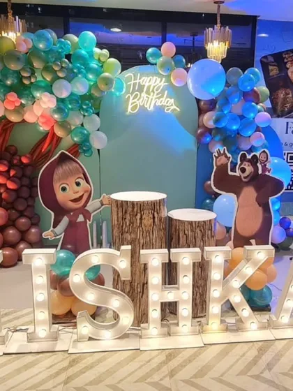 Another angle of the Masha and the Bear setup, showing how the different elements like the neon sign, cutouts, and marquee letters come together to create a complete and immersive themed backdrop.