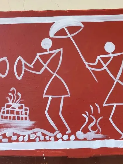 A close-up detail of a Warli mural border. You can see the simple, geometric forms used to create dynamic figures of musicians and dancers, showcasing the energy and narrative style of this tribal art form.
