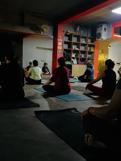 A dimly lit class setting the mood for a deep, introspective meditation session.