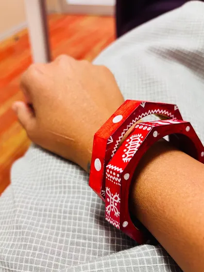 The Maati bangles have a special rustic charm. I use an earthy red color and paint them with patterns inspired by village art. They look beautiful stacked together as a pair.