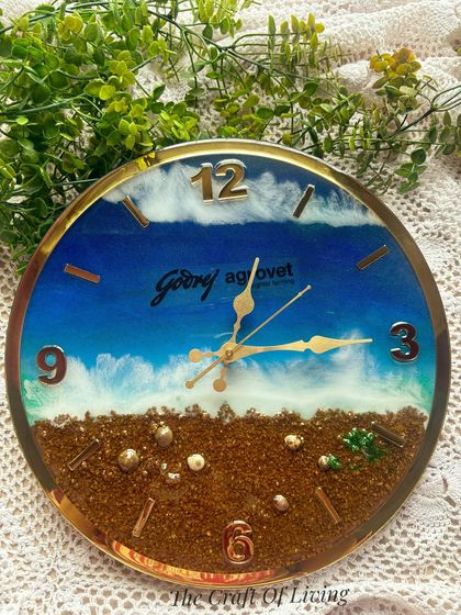 A top-down view of the Godrej Agrovet wall clock, highlighting the glossy finish and the beautiful blue and brown color palette of the sea theme.