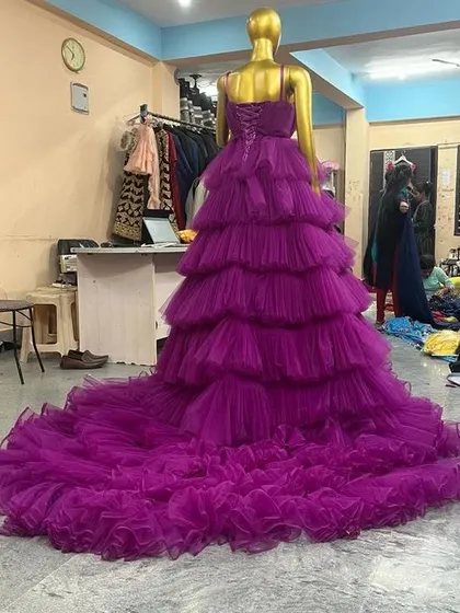 The back of our purple ruffled gown is just as impressive as the front. The long, tiered train and corset back create a dramatic and unforgettable silhouette.