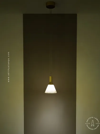 This single pendant light with a marble-finish shade and brass fitting is a study in minimalist elegance. It is perfect for providing focused task lighting or creating a soft ambient glow in a quiet corner.