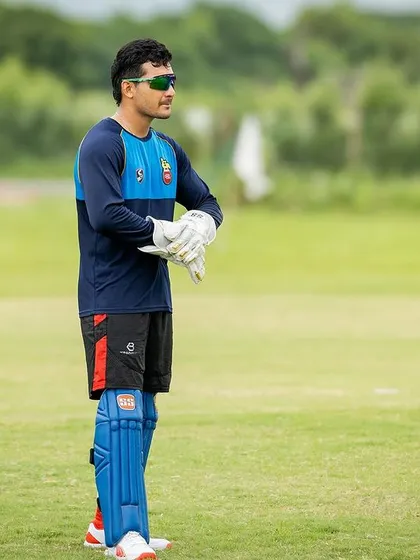 A wicketkeeper getting ready for action. My training ensures every player, regardless of their role, is in peak physical condition.