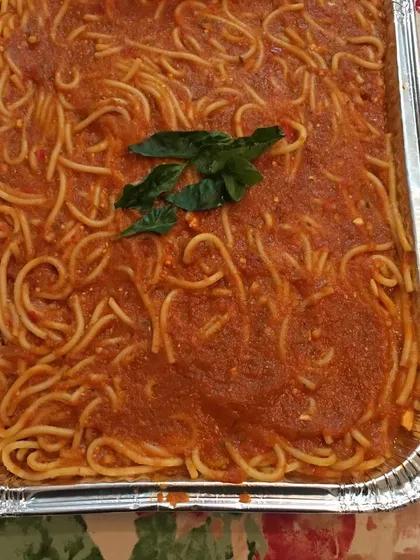 A simple, classic spaghetti in a homemade tomato sauce, topped with fresh basil. It's a crowd-pleasing dish that I often include in my Continental catering menus.