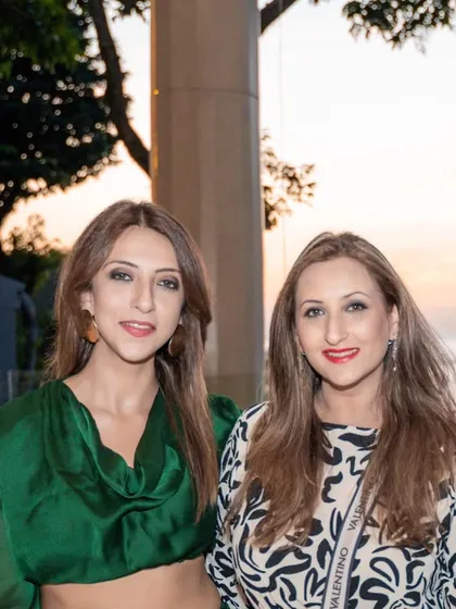 With my sister against a beautiful sunset backdrop in Thailand.