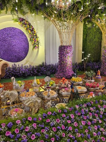 A detailed shot of the offering table for the purple floral stage, featuring silver swan and elephant props.