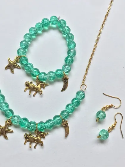 For the little dreamers, I designed this whimsical unicorn-themed jewellery set. It includes a matching necklace, bracelet, and earrings made with beautiful sea-green beads and charming gold-tone accents.