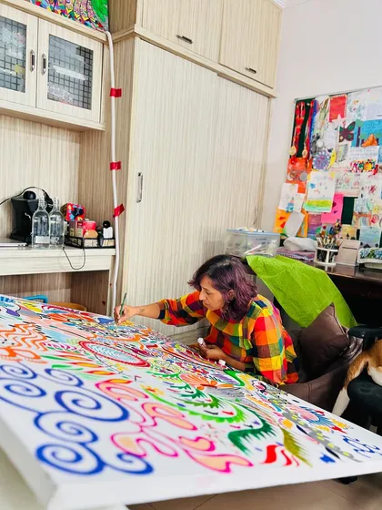 My home studio setup. I work on the floor to comfortably reach all corners of these large canvases. You can see my art supplies and inspiration board in the background.