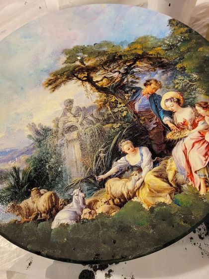 This is the base of a mix-media art piece before the resin pour. I use decoupage to apply these beautiful classical scenes, which then get transformed with layers of colorful and sparkling resin.