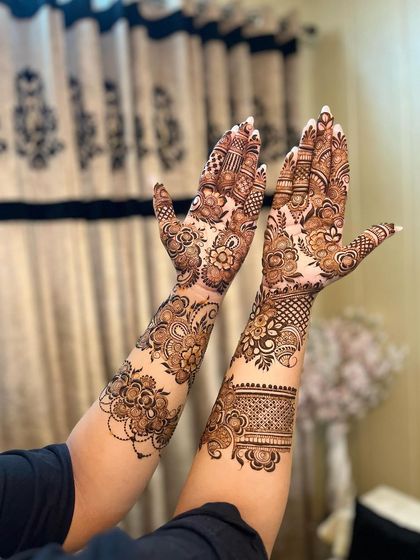 A beautiful and delicate floral vine design that wraps around the hands and arms.