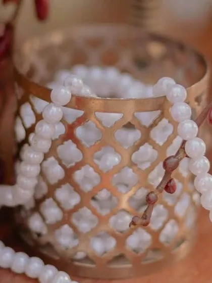 Small decor details like these pearl strings in ornate holders add layers of texture and elegance, contributing to the overall richness of the design.