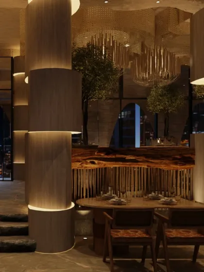 The ground floor at Zuvaah is a fluid, immersive landscape designed to accommodate over 200 guests. This view shows the interplay of sculptural columns, a live-edge wood table, and dramatic lighting.