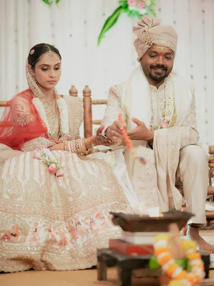 The couple participating in the sacred havan ceremony, a central part of the wedding rituals.
