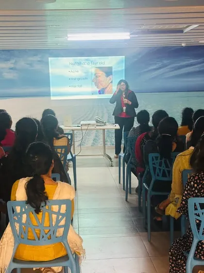 Sharing knowledge is a core part of my practice. Here I am speaking at a women's wellness event, educating the audience on skincare and answering their questions. Empowering others with scientific knowledge to care for their skin is something I am deeply passionate about.