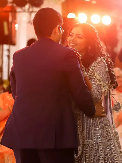 The couple's first dance as an engaged pair. I use the warm stage lighting to capture the joy and romance of this celebratory moment.
