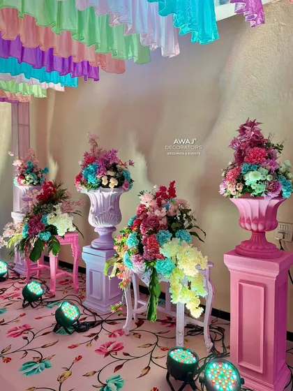 More of the beautiful pastel floral arrangements, lit by spotlights to enhance their colors.