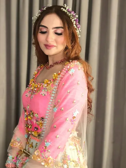 A close-up of the bride's makeup and the delicate flowers in her hair.
