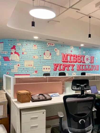 A concept-based wall mural for the Clovia office in Noida. This design, "Mission Fifty Million," uses fun typography and brand-related icons to create a motivational and visually engaging workspace.