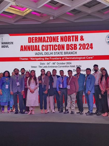 A group photo on stage at DERMAZONE NORTH 2024 with the organizing committee and other faculty members.
