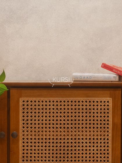 The top of the 'Kayo' cabinet, showing the smooth finish of the teak wood and the fine craftsmanship of the joinery.