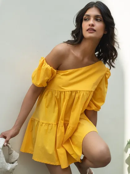 A dynamic pose in the yellow It Girl dress, highlighting its movement and cheerful color.