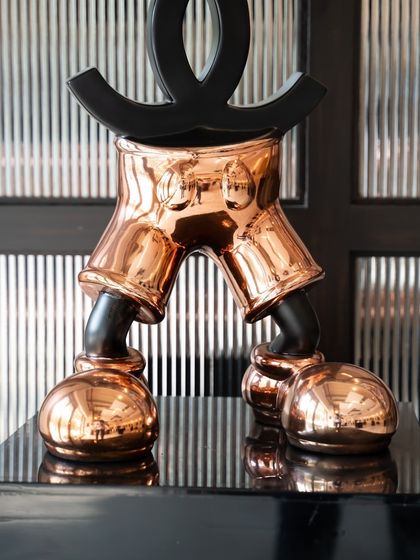 A view of the "Chanel Mickey" from behind, highlighting the contrast between the black logo and the gleaming chrome body.