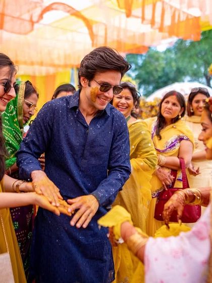 A family member participates in the Haldi rituals, a moment filled with smiles and tradition.